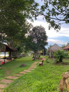a park with a bench in the grass at Biển Hồ Garden Glamping in Bien Ho