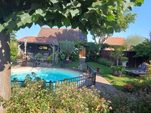 a swimming pool in the backyard of a house at B&B Le Jardin in Neerpelt
