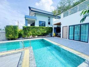 a swimming pool in front of a house at Ao Nang Private Rooftop Pool Villa 4BR l 8-10 Guests in Ao Nang 