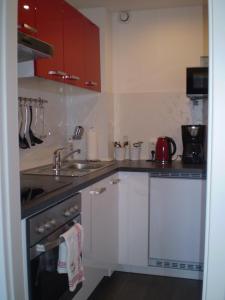a small kitchen with a sink and a stove at Ferienwohnung Marinablick in Wendtorf