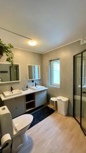 a bathroom with two sinks and a toilet at Villa Davvi dállu in Vidsel +67 photos