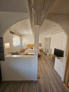 a bedroom with a bed and a living room at Mediterranean Studio in Saint-Cyprien