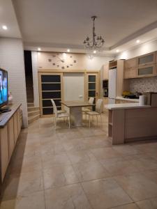 a kitchen with a table and chairs and a dining room at Gold Bugaz in Odesa