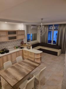 a kitchen with a table and chairs in a room at Gold Bugaz in Odesa