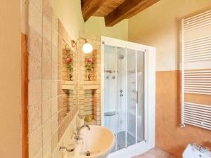 a bathroom with a sink and a glass shower at Relaxing Retreat in Le Marche in Monte San Martino