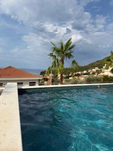 a swimming pool with a view of the ocean at Nicks sea view appartement II in Petrovac na Moru