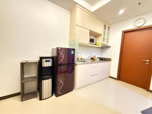 a kitchen with a stainless steel refrigerator in a room at 1 BR Comfy & Premium Entire Apt By Deeta Living in Jakarta