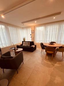a living room with a couch and a table at Christina's 2bed-Third Floor in Ostend