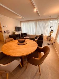 a living room with a wooden table and chairs at Christina's 2bed-Third Floor in Ostend
