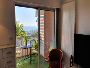 a room with a balcony with a table and a view at Apartment in Nice with Sea Views in Nice