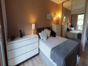 a bedroom with a bed with a dresser and a mirror at Apartment in Nice with Sea Views in Nice
