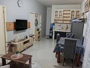a living room with a table and a kitchen at Your Home in Tagum City - Perfect for Families in San Isidro +19 photos