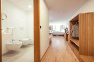 a bathroom with a white toilet and a sink at Ganischgerhof Mountain Resort & Spa in Nova Ponente +109 photos