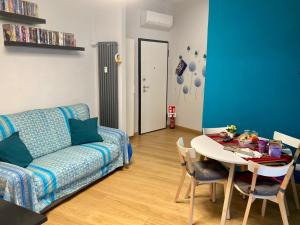a living room with a couch and a table at Sara’s Home in Turin