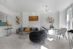 a living room with a couch and a table at 3 Bedroom Penthouse with Roof Terrace in Covent Garden in London