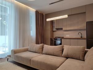 a living room with a couch and a kitchen at MONACO House in Chişinău +24 photos