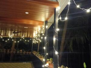 a string of lights on the side of a building at Dlite villa home stay in Revadanda