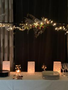 a table with plates and lights on it at Le Mas Bastide in Gaudonville