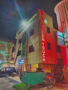 a building with a sign on the side of it at Hotel Golden Touch in Digha