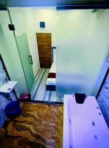 a small room with a bed and a toilet in it at royal guest house and dormitory in asalpha in Mumbai +23 photos