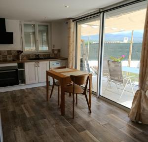 a kitchen with a table and a view of the ocean at T2 Les Roses in Le Beausset