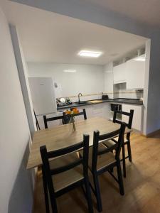a kitchen with a table and chairs in a room at La casita de Nicolás in Escarrilla