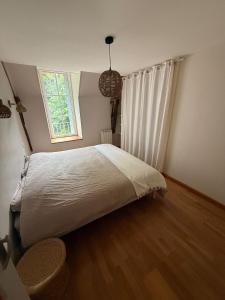 a bedroom with a large bed and a window at La Grange de la Boutelaye in Lésigny +15 photos