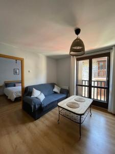 a living room with a couch and a table at La casita de Nicolás in Escarrilla