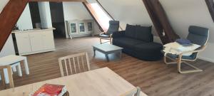 a living room with a couch and a table at Gites de Coulonge in Coulonges-Ardennes