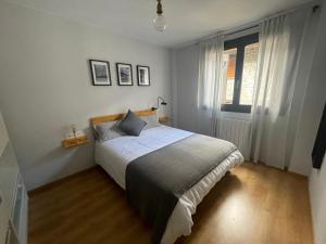 a bedroom with a bed and a window at La casita de Nicolás in Escarrilla