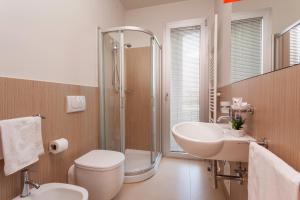 a bathroom with a toilet and a sink and a shower at Residence Delfina in Rimini +33 photos
