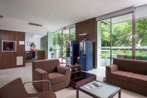 a living room with two chairs and a vending machine at Residence Delfina in Rimini