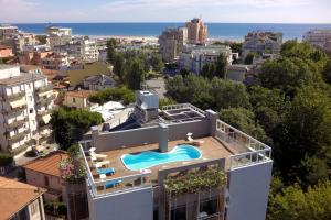 an apartment with a swimming pool on the roof of a building at Residence Delfina in Rimini