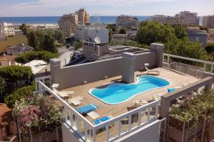 an aerial view of a building with a swimming pool at Residence Delfina in Rimini