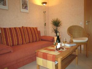 a living room with a couch and a coffee table at Vineyard View Romantic Stay in Kinheim