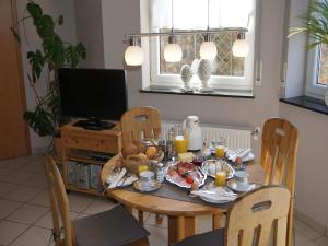 a dining room table with breakfast foods and orange juice at Romantischer Aufenthalt mit Blick auf den Weinberg in Kinheim