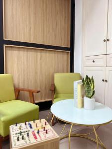 a room with two chairs and a chess board on a table at Hanoi Railway Capsule Hostel in Hanoi