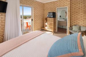 En eller flere senge i et værelse på Baywatch Retreat Augusta