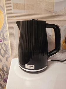 a black coffee pot sitting on top of a table at KLEOPÁTRA Apartman HAJDÚSZOBOSZLÓ in Hajdúszoboszló +44 photos