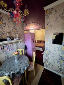 a dining room with a table and a room with a bed at KLEOPÁTRA Apartman HAJDÚSZOBOSZLÓ in Hajdúszoboszló