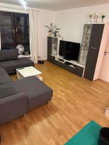 a living room with a couch and a flat screen tv at Private Wohnung im Herzen Kölns in Cologne