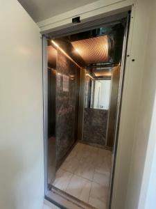 a shower in a room with a glass door at Αβαντιάς Abantias in Loutra Edipsou +30 photos