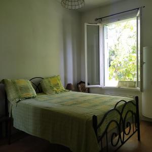 a bedroom with a large bed with a window at Charme et jardin in Toulouse