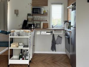a small kitchen with a sink and a refrigerator at Chalet Oostkapelle in Oostkapelle