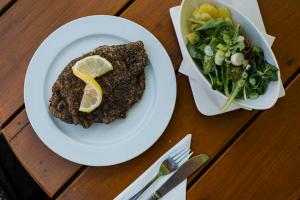 a table with a plate of food and a salad at Gasthof Speneder in Altpölla