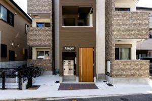a building with a brown door in front of it at エルモス唐人 in Muromimachi +10 photos