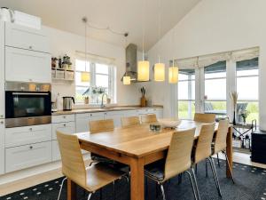 a kitchen with a wooden dining room table and chairs at 4 star holiday home in Nysted in Nysted