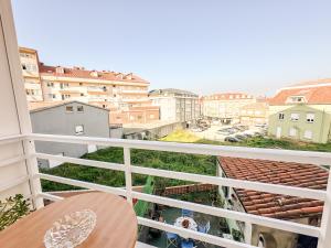 a balcony with a view of a city at Apartamento Susurros do Atlántico by ALÔGA in Fisterra