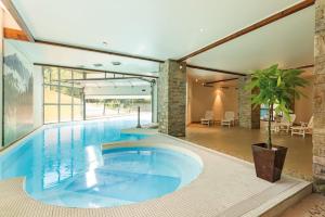 a large swimming pool in a large building at Appartement T2 Vue montagne in Cauterets