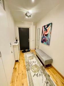 a living room with a couch and a painting on the wall at Stylish City Apartment Stockholm in Stockholm